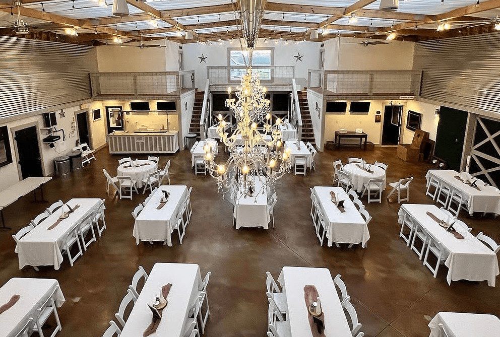The Grand Hall set for a reception with chandeliers and bistro lights
